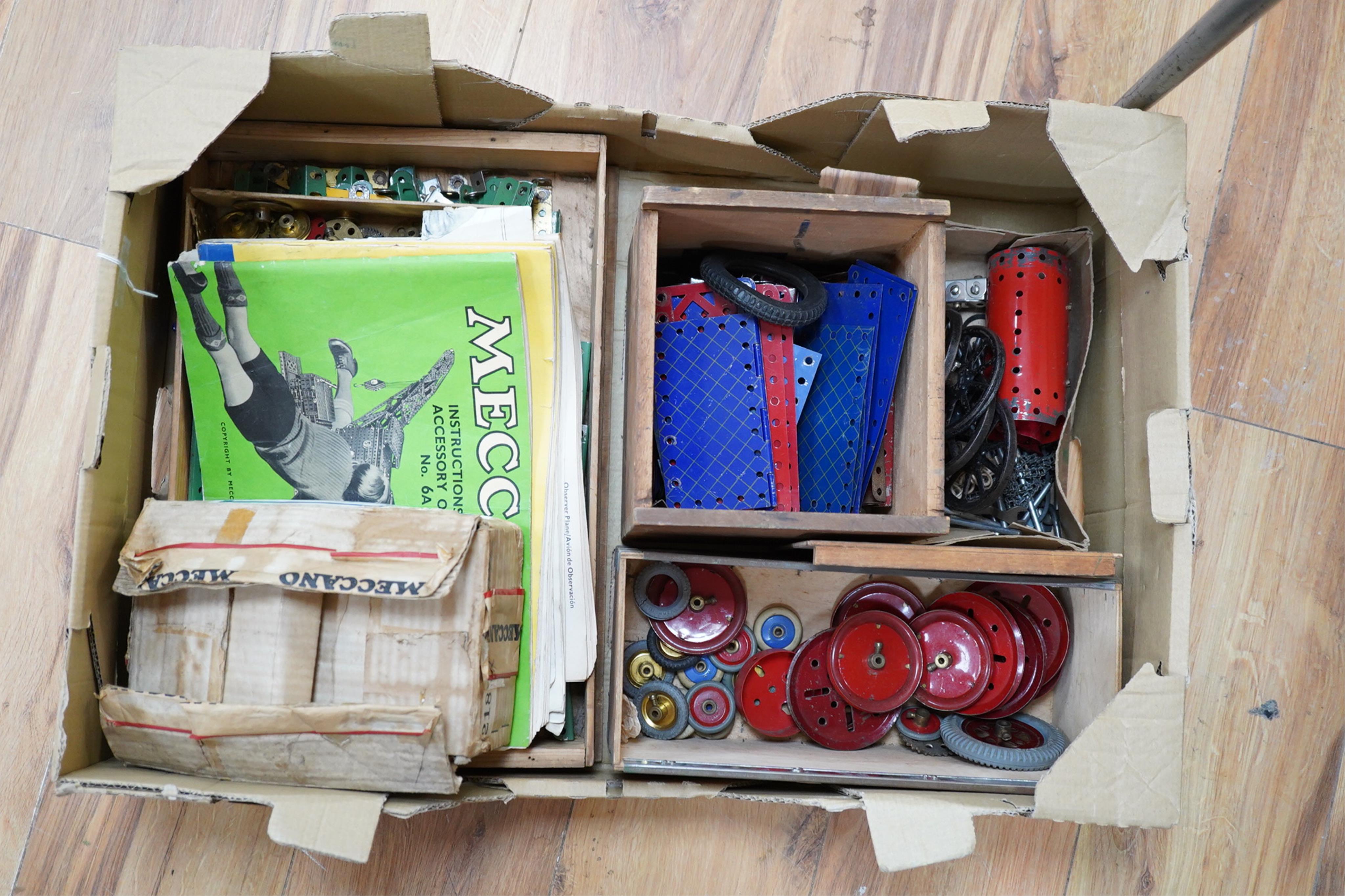 A collection of Meccano parts, including aeroplane parts, instruction manuals, etc. Condition - fair